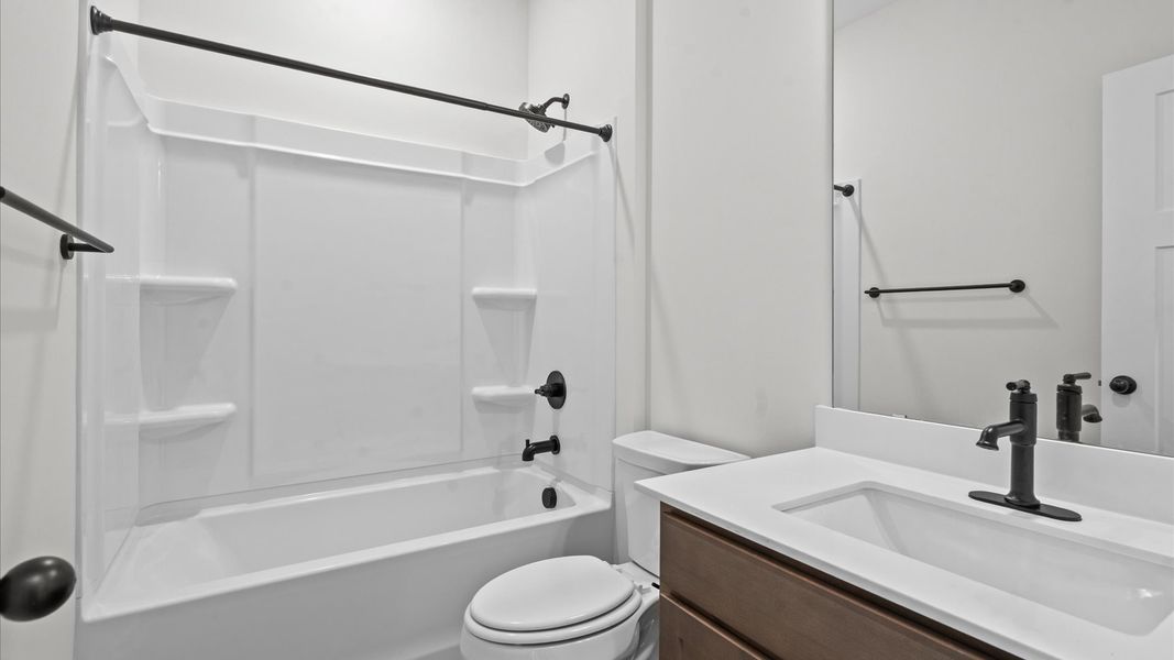 Accomplished bathroom design with sleek tile, high-quality cabinetry, and refined hardware Accomplished bathroom design with sleek tile, high-quality cabinetry, and refined hardware