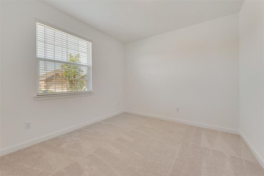 Empty room with light colored carpet