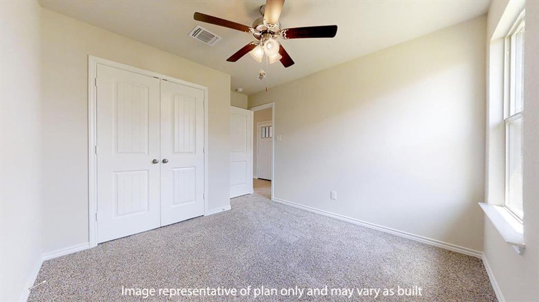 Unfurnished bedroom featuring carpet flooring, multiple windows, a closet, and a ceiling fan Unfurnished bedroom featuring carpet flooring, multiple windows, a closet, and a ceiling fan