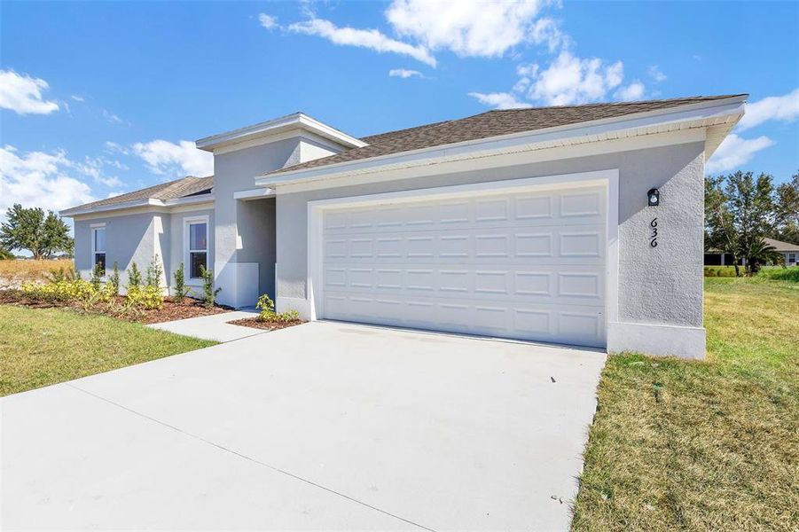 Front exterior of a new home in Grand Oaks, Avon Park, FL, highlighting curb appeal (Image 7).