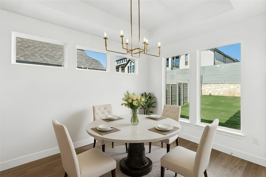 Dining area featuring wood finished floors and a chandelier