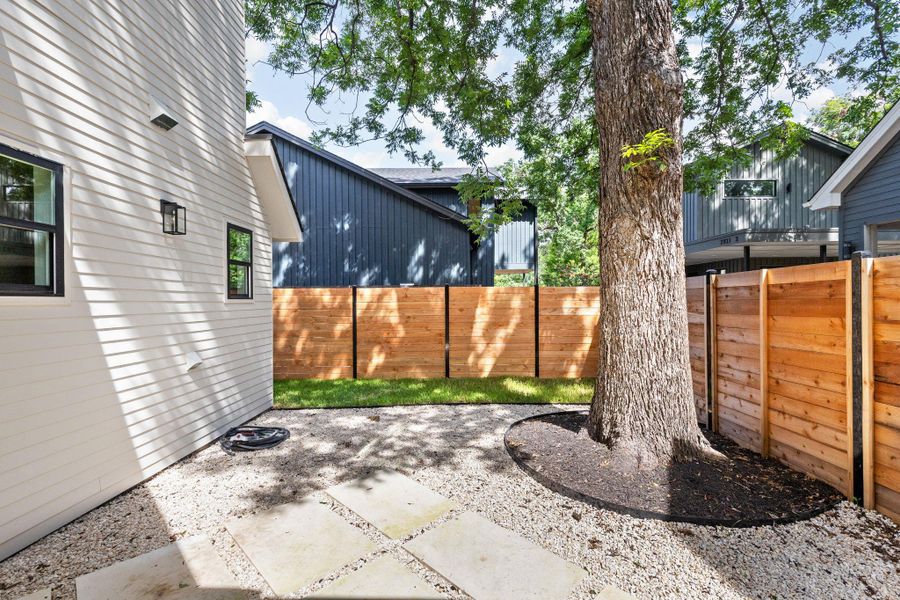 Fenced backyard with a patio area Fenced backyard with a patio area