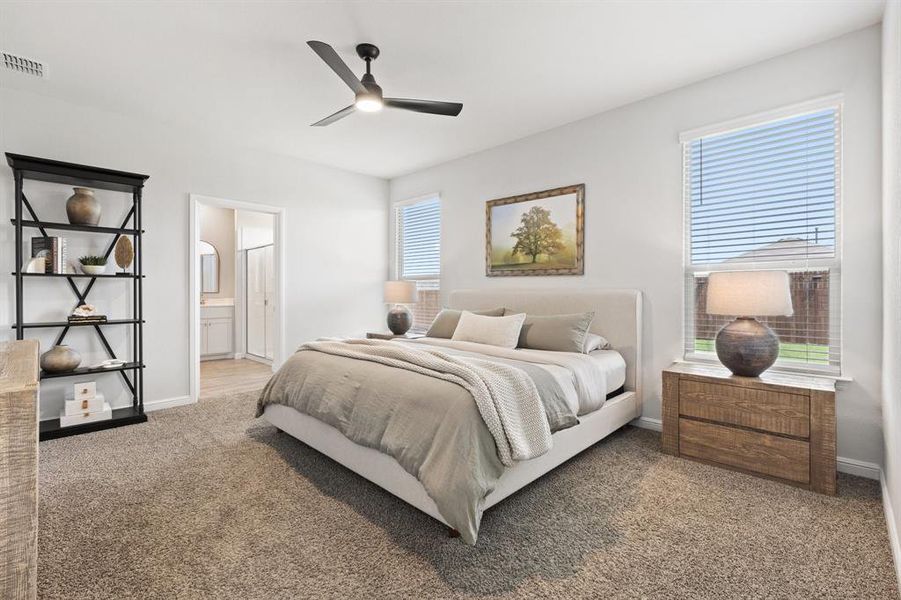 Primary Bedroom located off the dining area & kitchen, with an ensuite bathroom, a ceiling fan and carpet Primary Bedroom located off the dining area & kitchen, with an ensuite bathroom, a ceiling fan and carpet