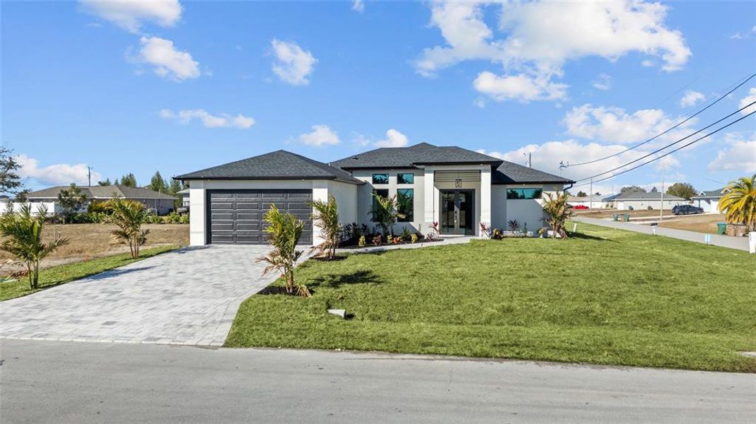 Front exterior of a new home in , Cape Coral, FL, highlighting curb appeal (Image 1). Front exterior of a new home in , Cape Coral, FL, highlighting curb appeal (Image 1).