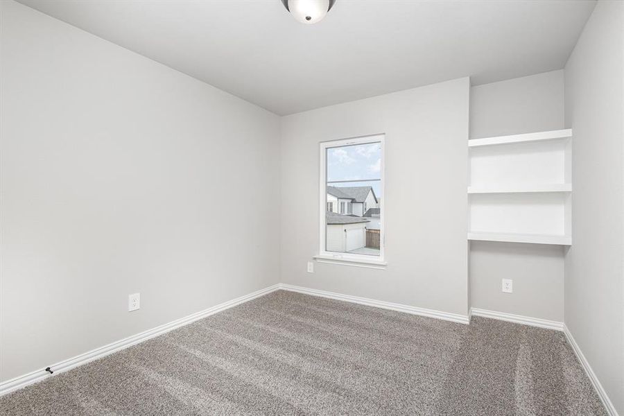 Empty room featuring carpet flooring and baseboards
