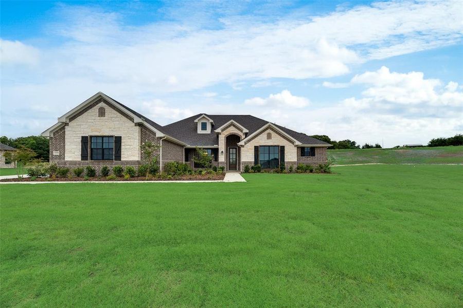Front exterior of a new home in King Crossing Estates, Van Alstyne, TX, highlighting curb appeal (Image 2). Front exterior of a new home in King Crossing Estates, Van Alstyne, TX, highlighting curb appeal (Image 2).