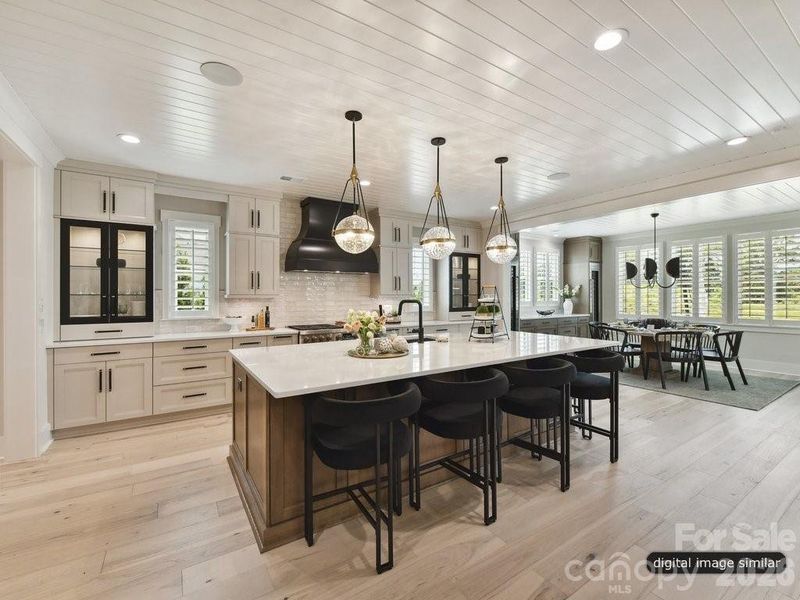 Large Luxury Kitchen has an island with seating for six