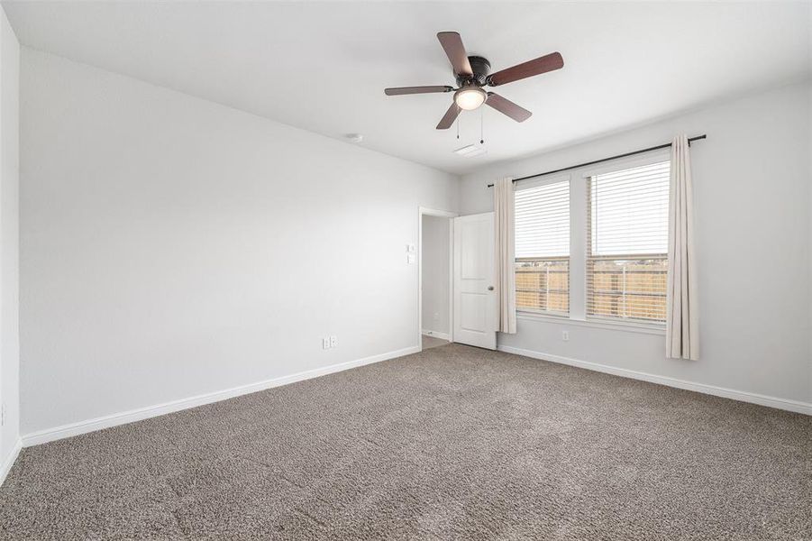 Unfurnished room with carpet floors and ceiling fan