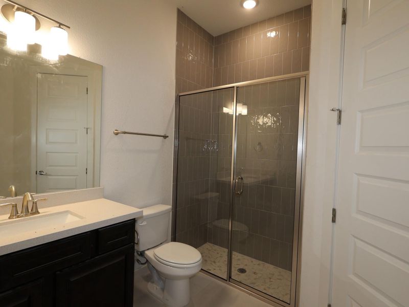 Full bathroom with vanity, a stall shower, tile patterned floors, and recessed lighting