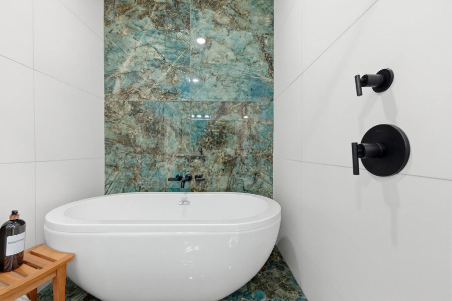 Bathroom with tile walls and a soaking tub Bathroom with tile walls and a soaking tub