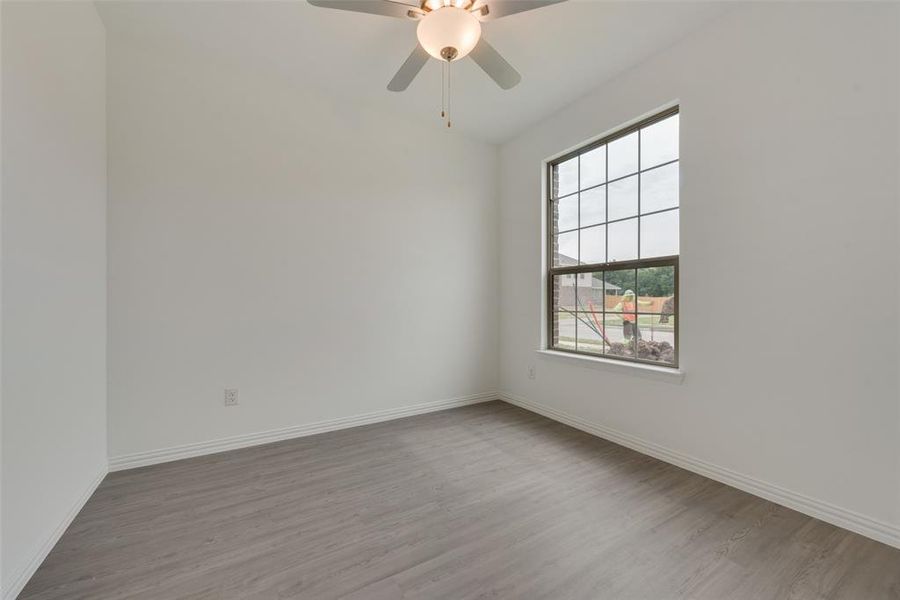 Unfurnished room featuring ceiling fan and light hardwood / wood-style flooring