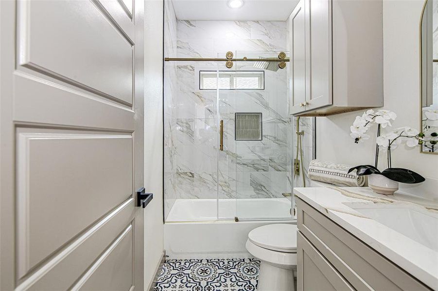 Bathroom with vanity, combined bath / shower with glass door, tile patterned flooring, and recessed lighting