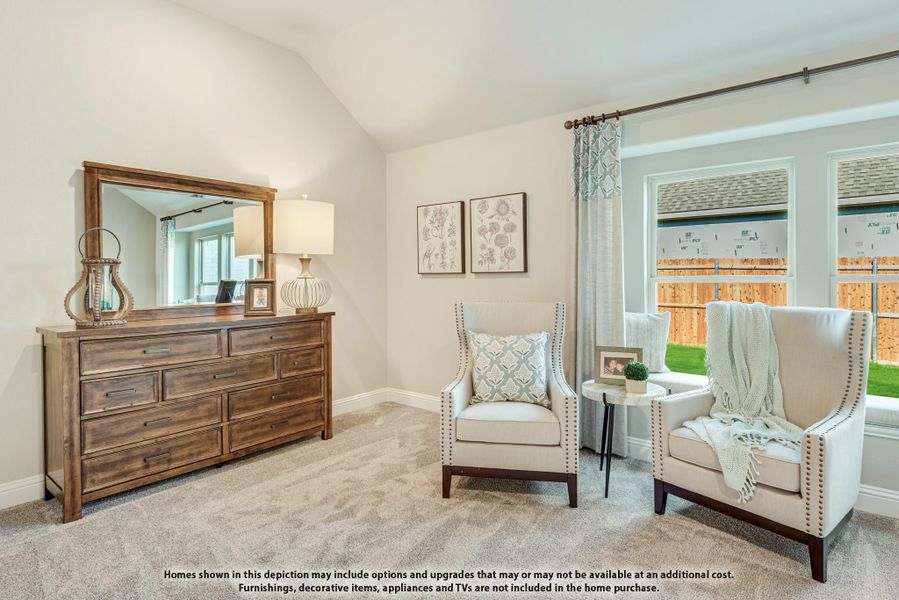 Bedroom sitting area with two white armchairs, wood dresser with mirror, and vaulted ceiling near large windows Bedroom sitting area with two white armchairs, wood dresser with mirror, and vaulted ceiling near large windows