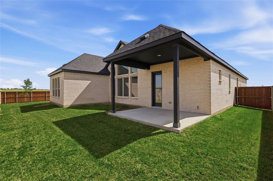 Rear view of property featuring a fenced backyard, a patio area, and brick siding Rear view of property featuring a fenced backyard, a patio area, and brick siding