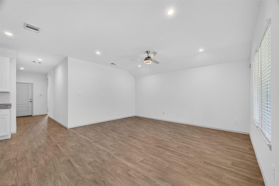 An unstaged view of the living room, giving you a clear look at the spacious layout and blank canvas. An unstaged view of the living room, giving you a clear look at the spacious layout and blank canvas.