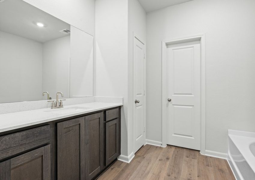 The master bathroom has a large vanity space.