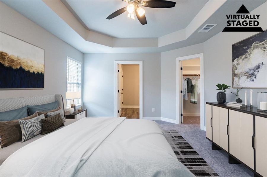 Primary bedroom virtually staged_ walk in closet, beautiful bath , raised ceiling, fans, window treatments - ready to move in!