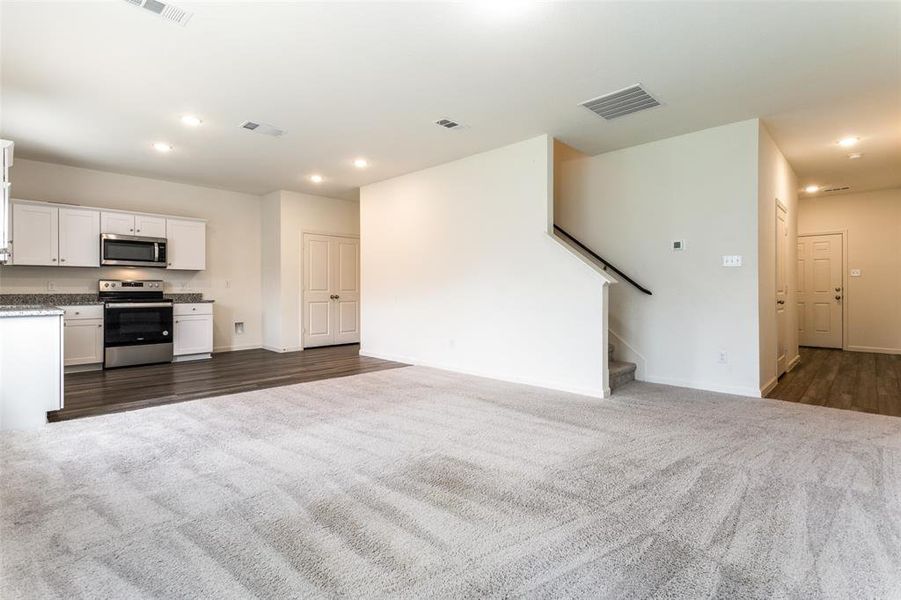 Unfurnished living room with dark colored carpet