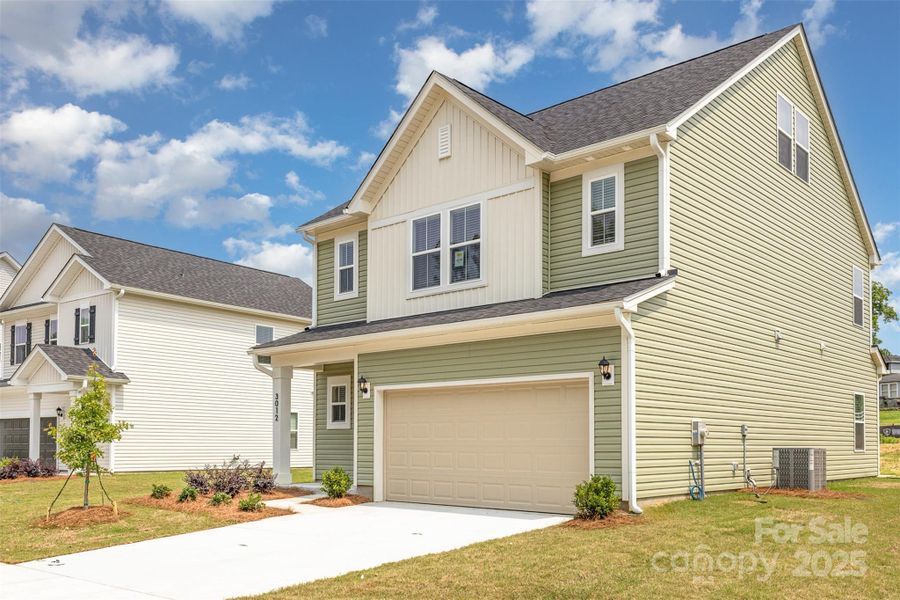 Double-car garage & concrete driveway. Representative Photo.