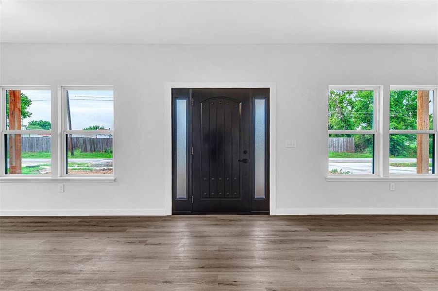Foyer featuring wood finished floors and baseboards