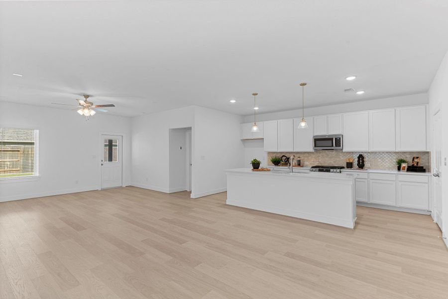 The expansive family room offers the perfect setting for entertaining or simply relaxing. Enjoy the seamless connection to the kitchen and dining spaces, ideal for gatherings, celebrations, and cozy evenings at home. **Image Representative of Plan Only and May Vary as Built**.