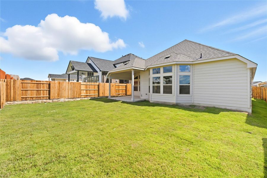 Back of property featuring a shingled roof, a patio area, and a fenced backyard Back of property featuring a shingled roof, a patio area, and a fenced backyard