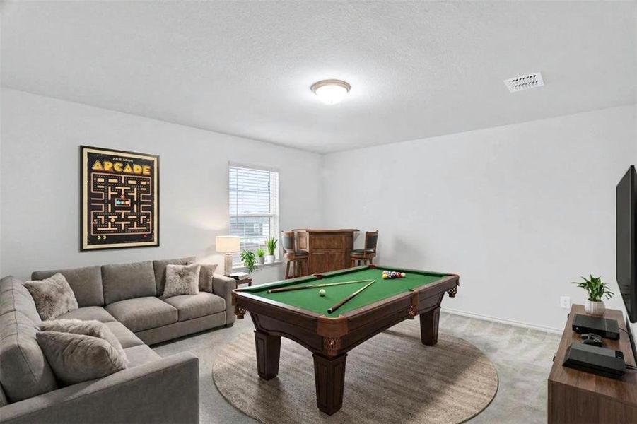 Carpeted bonus room featuring a window with blinds, ceiling-mounted light fixture, and white walls