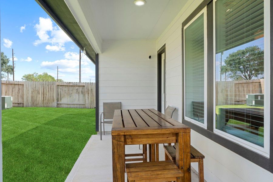 Covered back patio with space for outdoor dining or weekend lounging — perfect for enjoying fresh air and entertaining friends. Covered back patio with space for outdoor dining or weekend lounging — perfect for enjoying fresh air and entertaining friends.