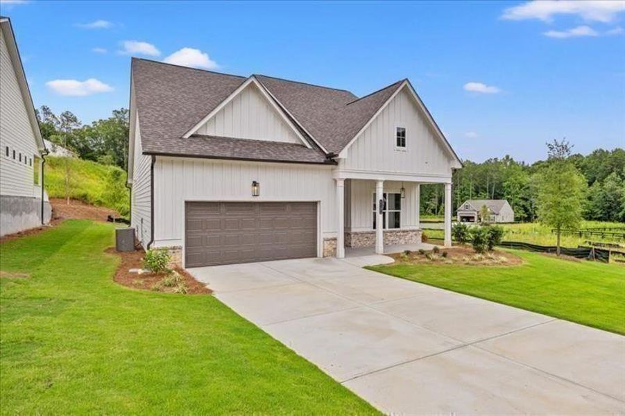 Front exterior of a new home in Cooks Farm, Woodstock, GA, highlighting curb appeal (Image 1). Front exterior of a new home in Cooks Farm, Woodstock, GA, highlighting curb appeal (Image 1).