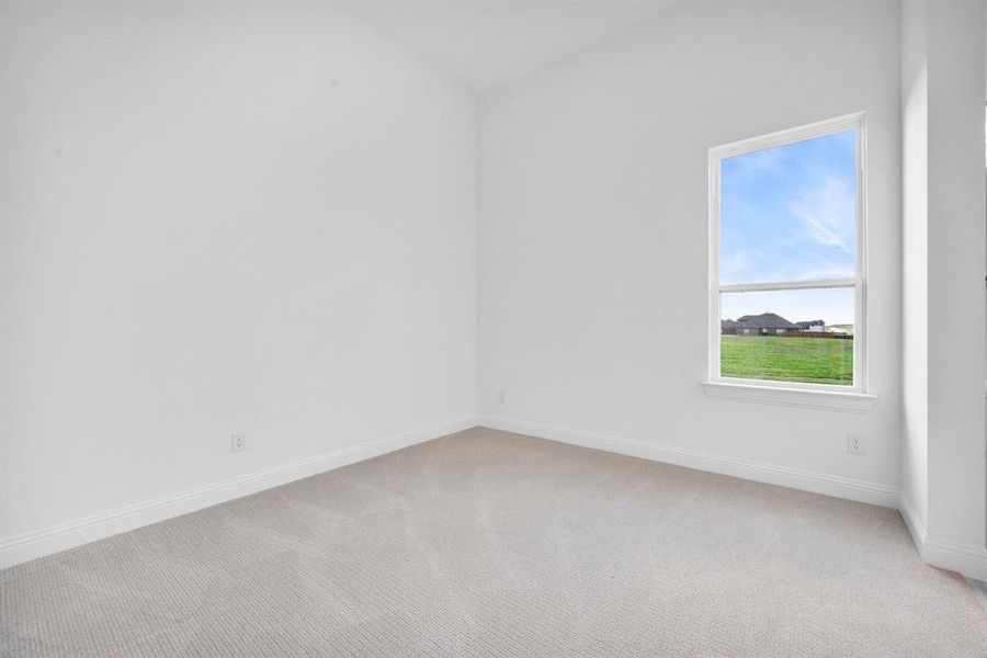 Spare bedroom with light carpet