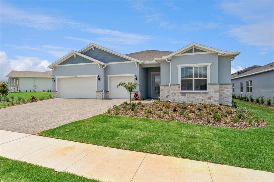 Front exterior of a new home in , Minneola, FL, highlighting curb appeal (Image 2). Front exterior of a new home in , Minneola, FL, highlighting curb appeal (Image 2).