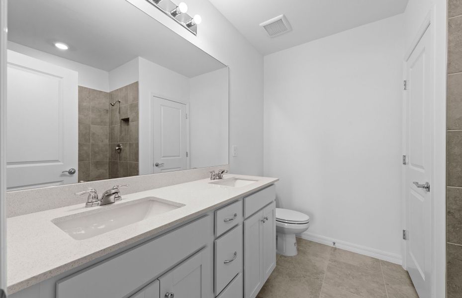 Owner's bathroom with dual-sink vanity and spacious shower Owner's bathroom with dual-sink vanity and spacious shower