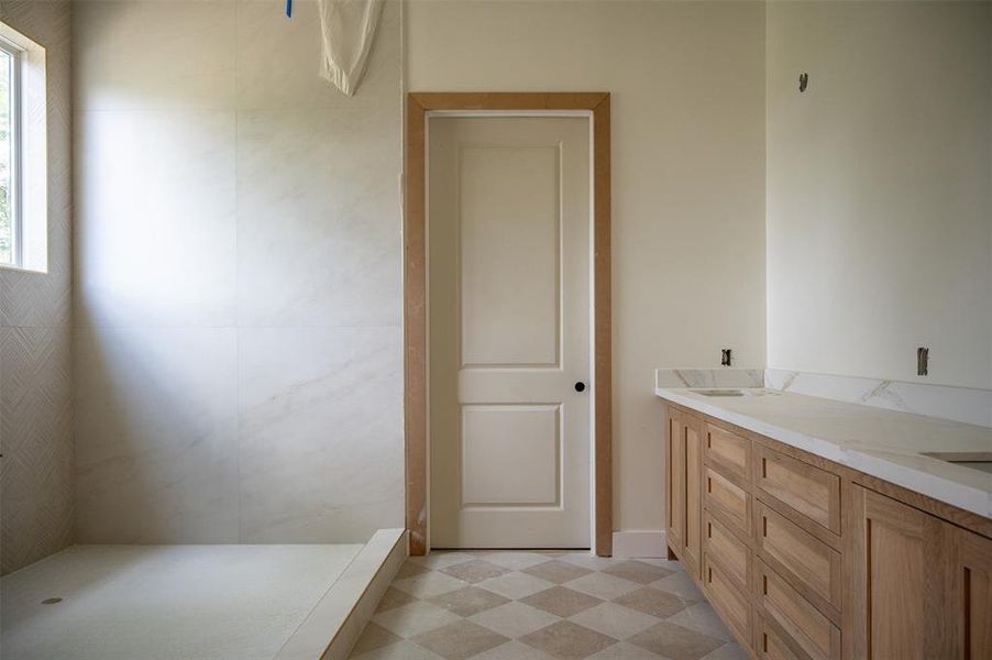 One of a kind checkered floors in the primary bathroom and laundry room.