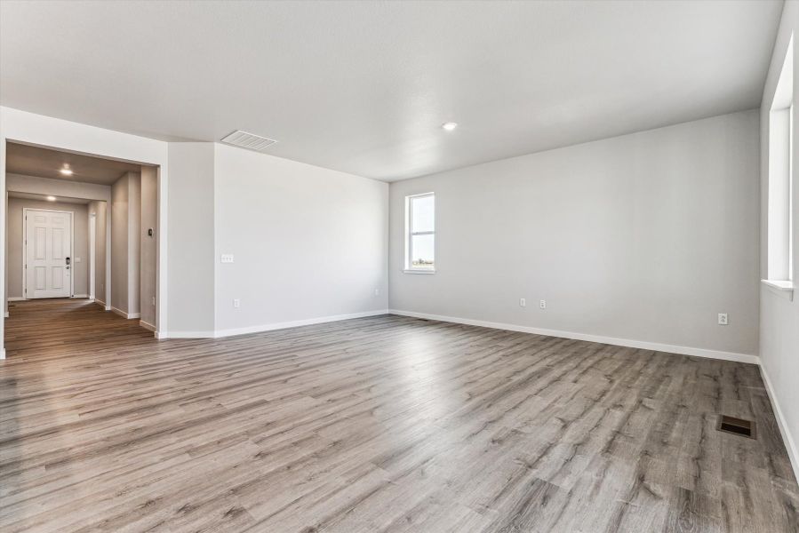 A room with a wood floor and a wood floor.