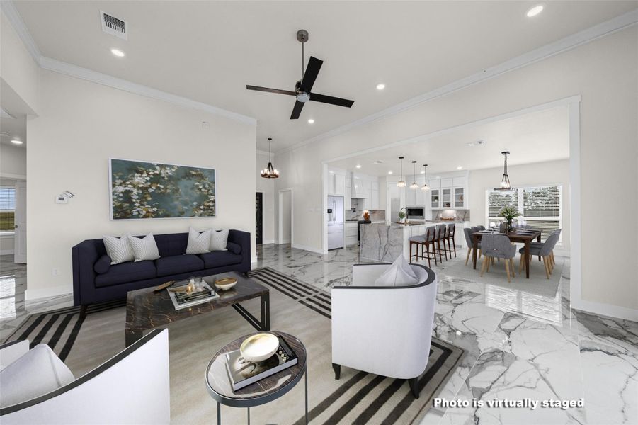 Polished tile flooring flows seamlessly through an expansive open living area into the kitchen.