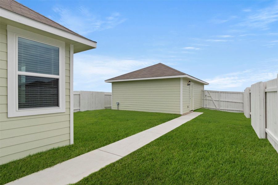 Fenced backyard featuring an outbuilding Fenced backyard featuring an outbuilding