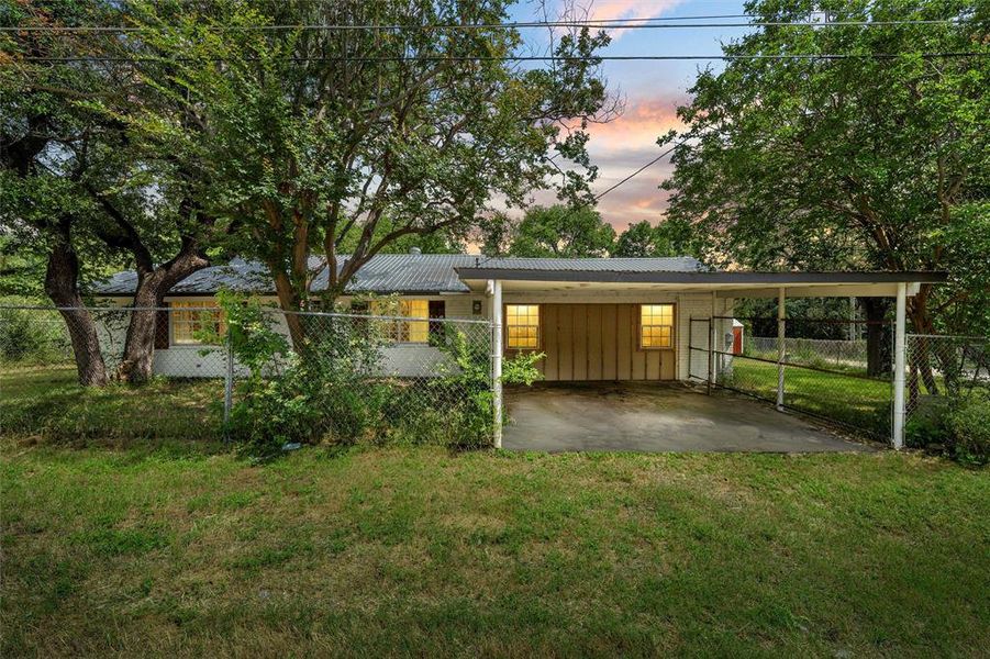 View of front of home featuring a carport, metal roof, and board and batten siding View of front of home featuring a carport, metal roof, and board and batten siding