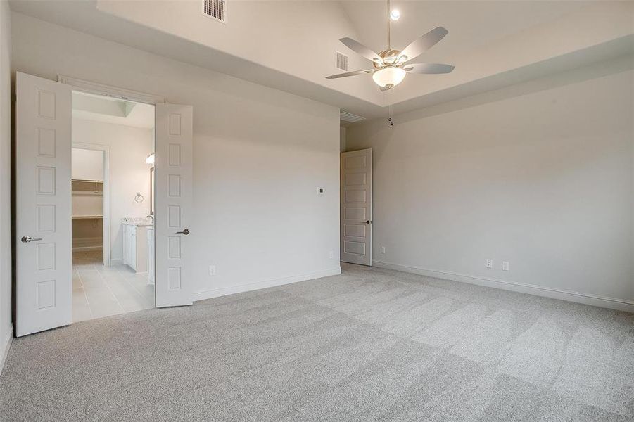 Unfurnished room featuring light colored carpet and ceiling fan