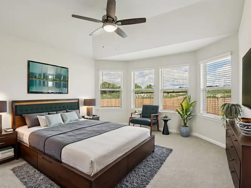 Virtually staged primary suite in the Oleander floorplan at a Meritage Homes community.