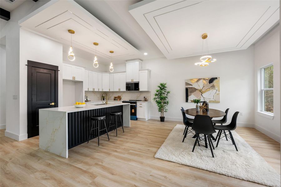 Dining room with light wood-style flooring and a chandelier Dining room with light wood-style flooring and a chandelier
