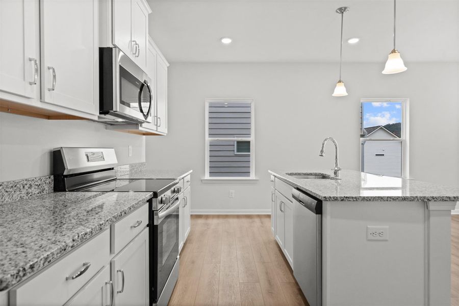 The Dove- Kitchen. Home under construction, photo used for illustrative purposes only, colors and options will vary.