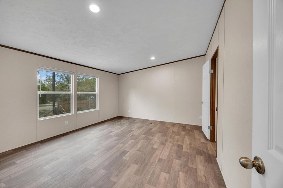 Unfurnished room featuring light wood-style flooring, ornamental molding, and recessed lighting