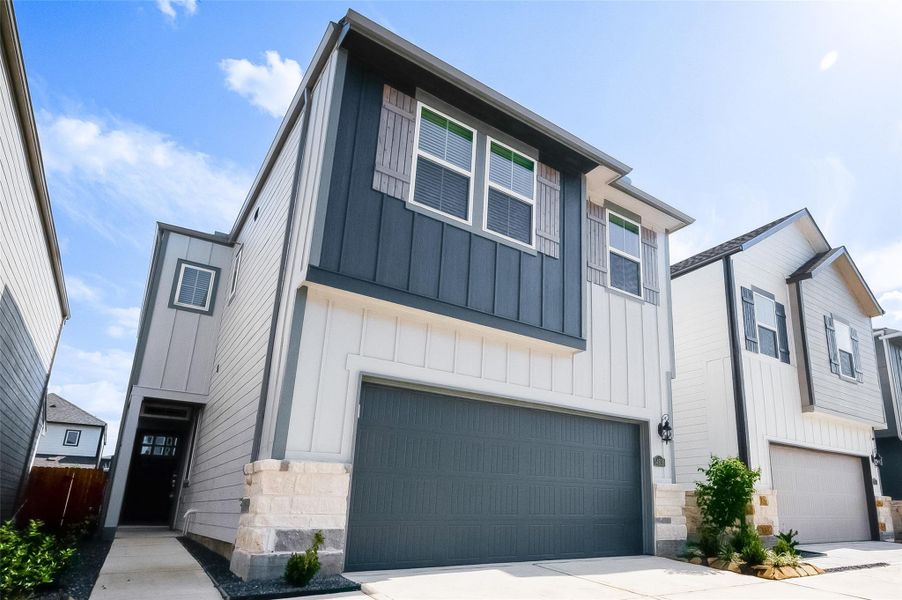 Front exterior of a new home in McClendon Park Village, Houston, TX, highlighting curb appeal (Image 27). Front exterior of a new home in McClendon Park Village, Houston, TX, highlighting curb appeal (Image 27).