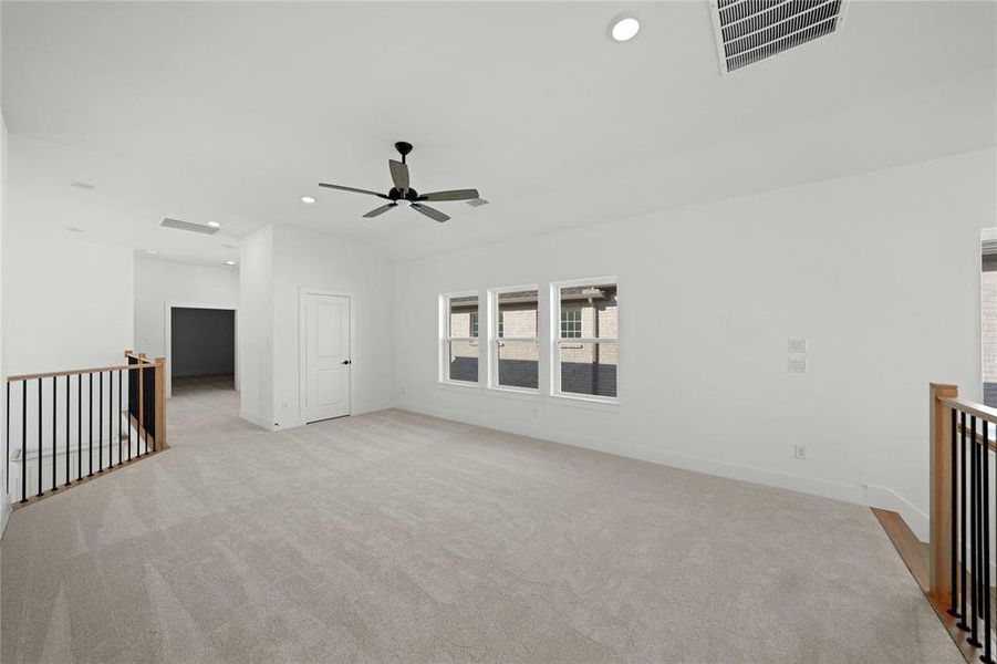 Spare room featuring recessed lighting, light carpet, and a ceiling fan Spare room featuring recessed lighting, light carpet, and a ceiling fan