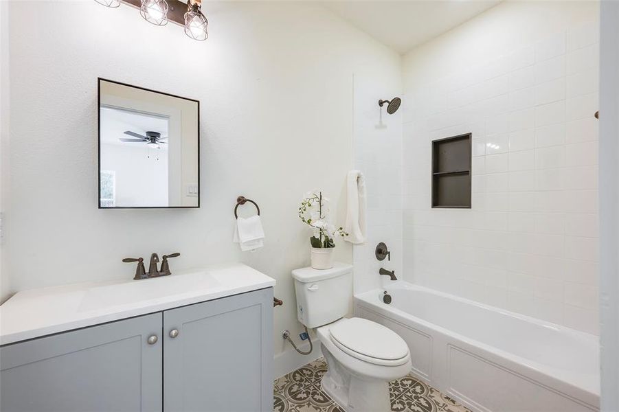 Full bathroom with vanity, shower / tub combination, and light tile patterned floors