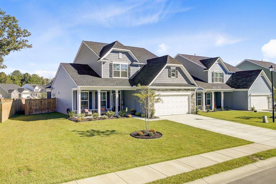 Front exterior of a new home in Oakley Pointe, Moncks Corner, SC, highlighting curb appeal (Image 2).