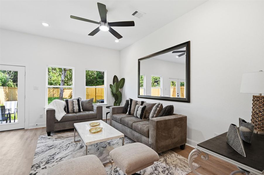 Open concept kitchen, dining and living room, with lots of natural light.