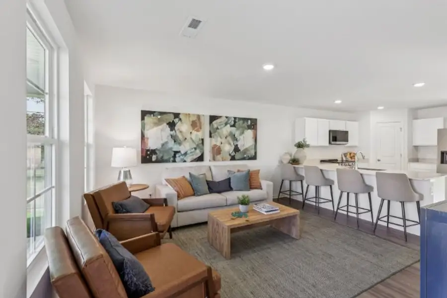 A living room with a large dining table and couches.