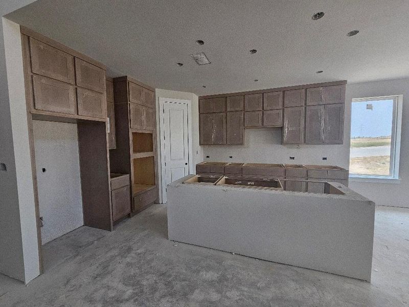 Kitchen with concrete flooring Kitchen with concrete flooring