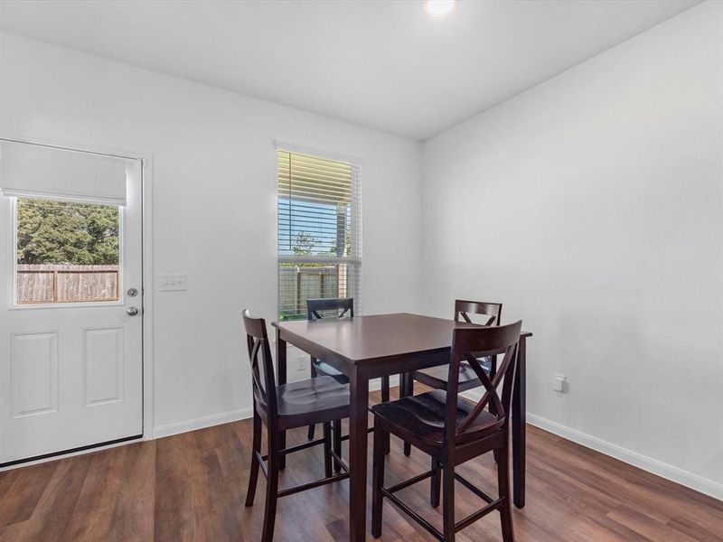 Adjacent dining space with tranquil backyard views